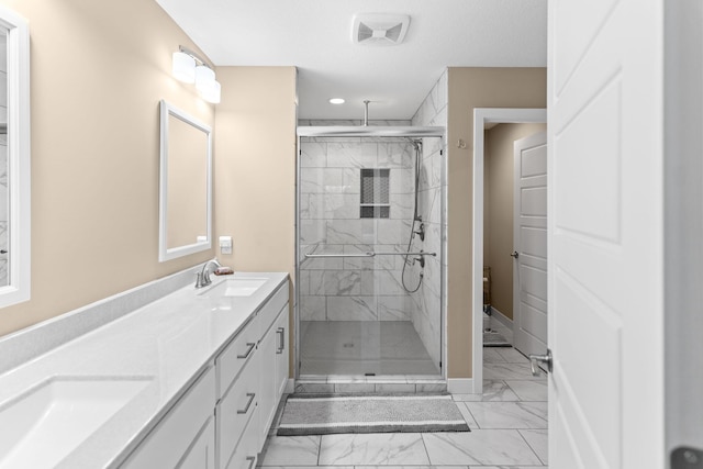 full bath with a shower stall, marble finish floor, and a sink