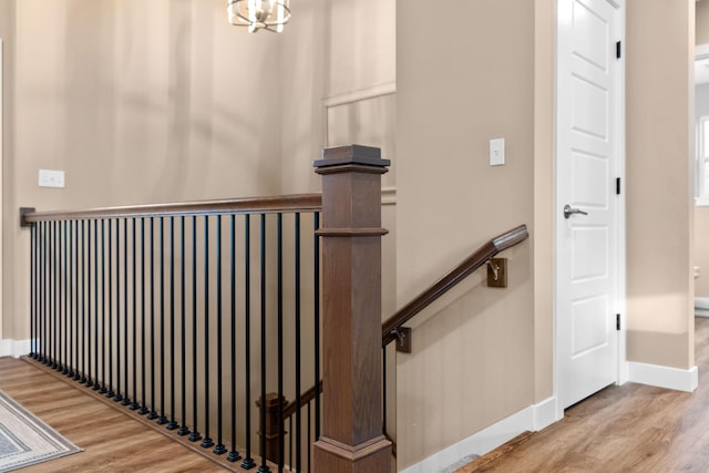 stairs with baseboards and wood finished floors