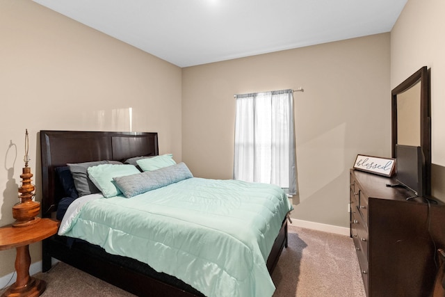 carpeted bedroom featuring baseboards