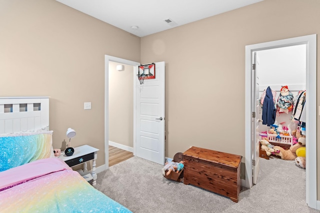 bedroom with visible vents, carpet, and baseboards