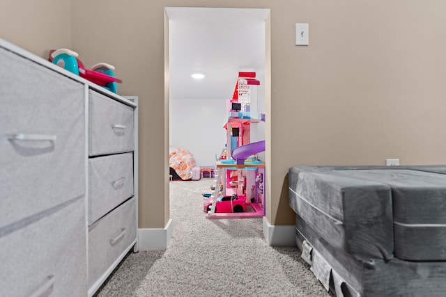 interior space featuring carpet flooring and baseboards