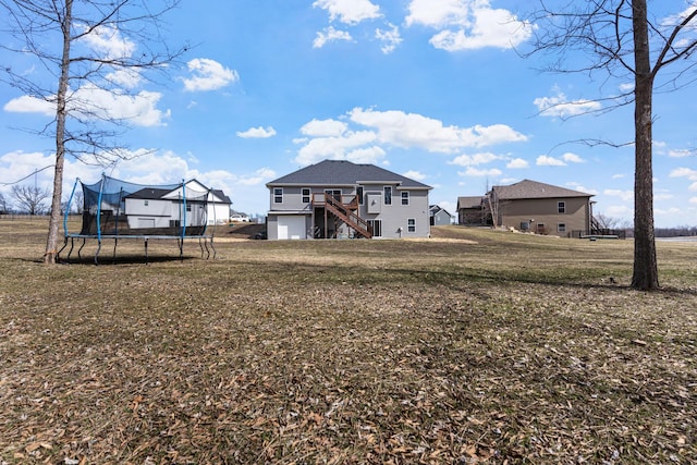 view of yard with stairway, a trampoline, and a deck