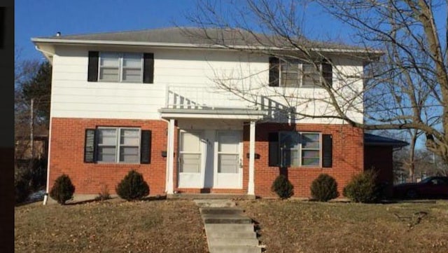 traditional-style house with brick siding