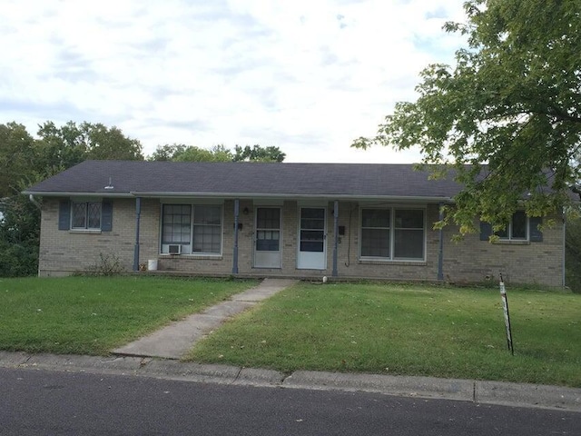 ranch-style home with a front lawn and brick siding