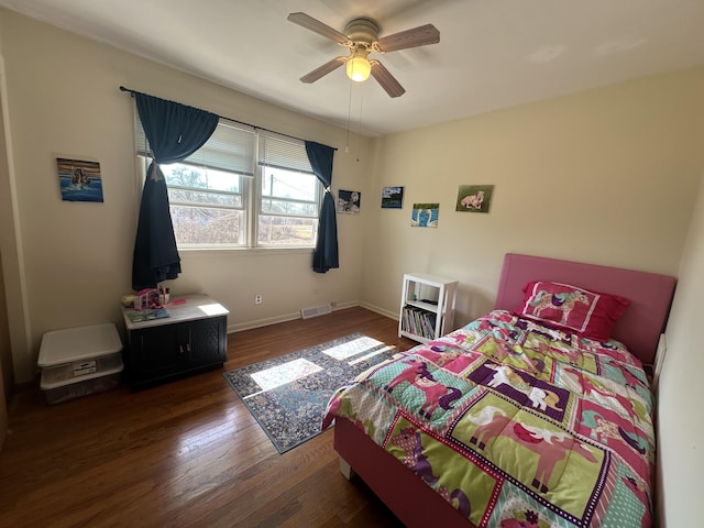 bedroom with ceiling fan, visible vents, baseboards, and wood finished floors