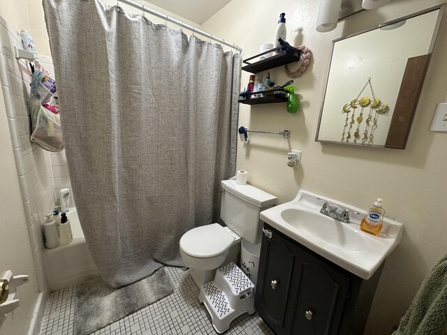 full bath featuring vanity, tile patterned floors, shower / tub combo, and toilet