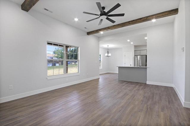 unfurnished living room featuring beam ceiling, visible vents, and baseboards