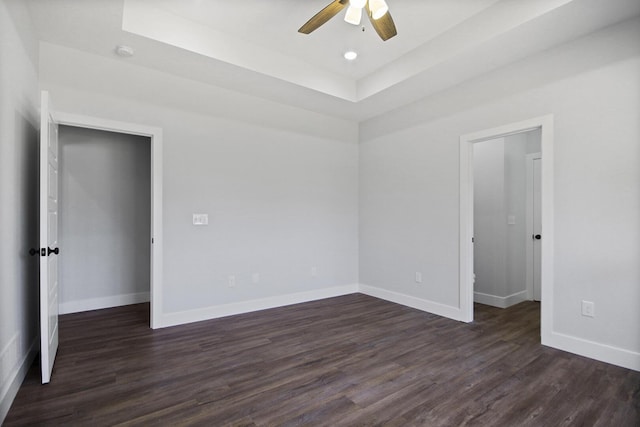 interior space featuring dark wood-style flooring and baseboards