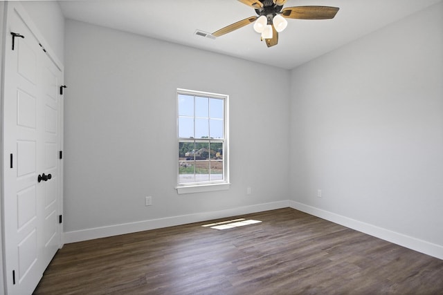 unfurnished bedroom with baseboards, visible vents, dark wood finished floors, and a ceiling fan