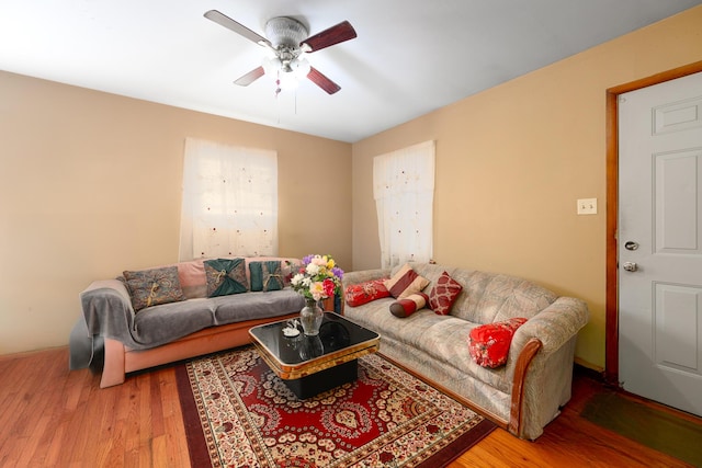 living area with ceiling fan and wood finished floors