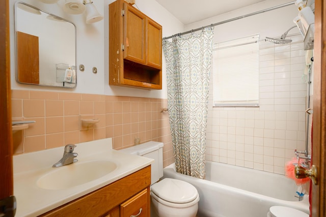 full bathroom featuring toilet, vanity, tile walls, and shower / tub combo with curtain