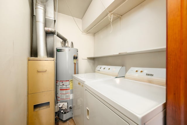 washroom featuring laundry area, water heater, and independent washer and dryer