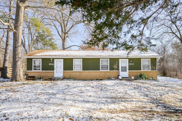 ranch-style home with entry steps and brick siding