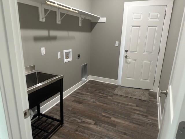 laundry area featuring laundry area, baseboards, dark wood-type flooring, hookup for a washing machine, and hookup for an electric dryer