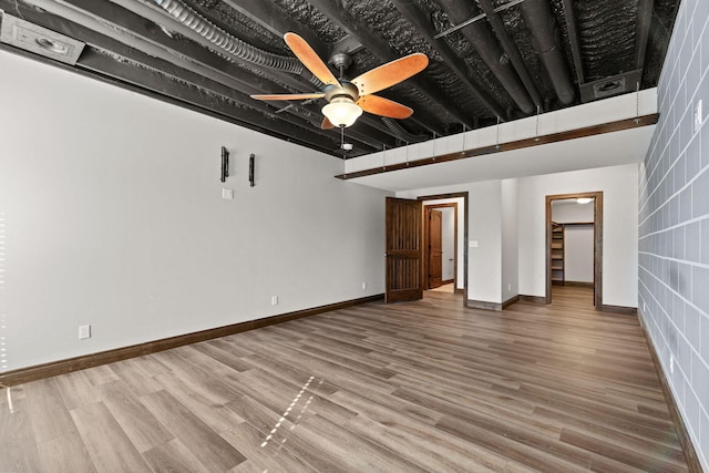 interior space featuring baseboards, wood finished floors, and a ceiling fan