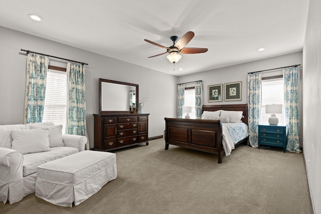 carpeted bedroom featuring recessed lighting and multiple windows