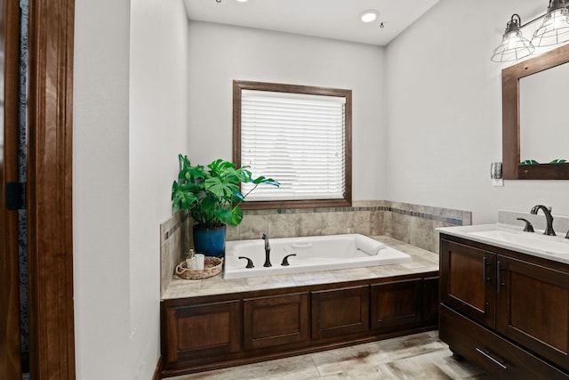 full bathroom with vanity and a garden tub