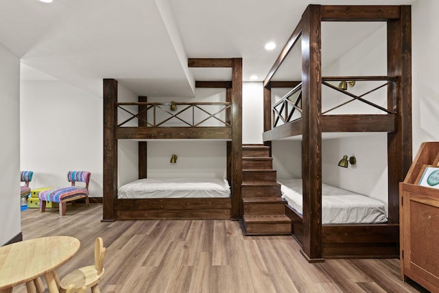 bedroom with recessed lighting and wood finished floors