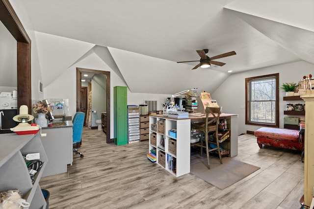 office space featuring a ceiling fan, lofted ceiling, wood finished floors, and visible vents