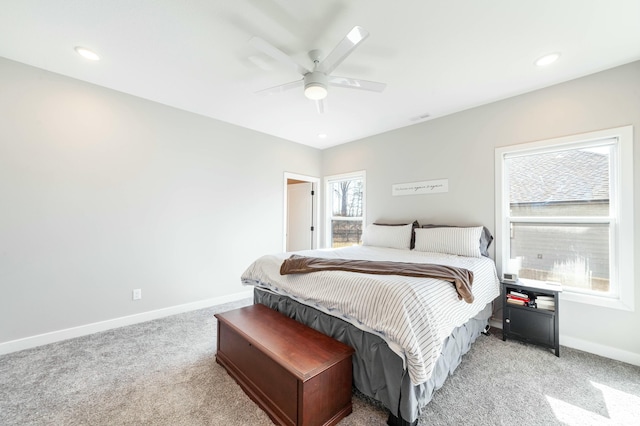 bedroom featuring a ceiling fan, recessed lighting, light colored carpet, and baseboards