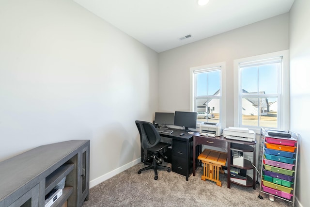 carpeted home office with visible vents and baseboards