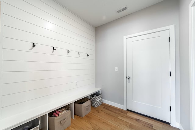 mudroom with light wood-type flooring, visible vents, and baseboards