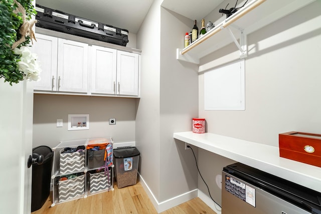 laundry room with washer hookup, light wood finished floors, cabinet space, electric dryer hookup, and baseboards