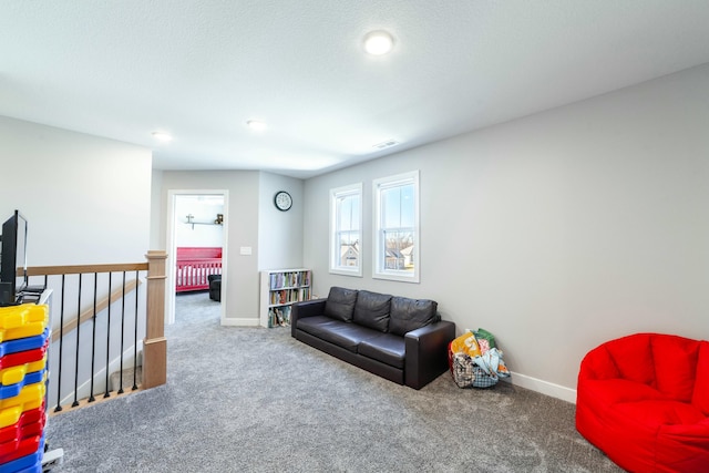 living room with carpet flooring, visible vents, and baseboards