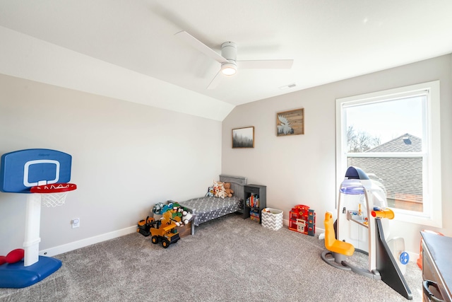 carpeted bedroom featuring visible vents, vaulted ceiling, ceiling fan, a nursery area, and baseboards