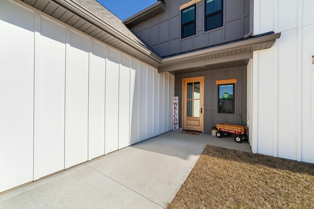 view of exterior entry with board and batten siding