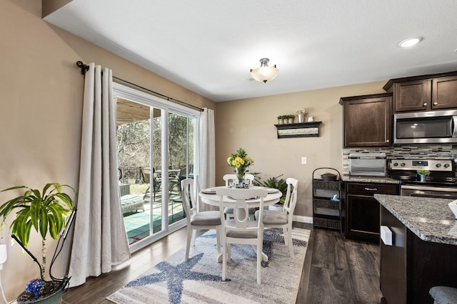 dining area with dark wood-style floors and baseboards