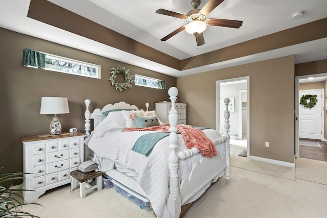 bedroom with carpet flooring, ceiling fan, ensuite bathroom, and baseboards