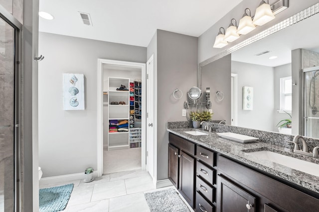 bathroom with a shower stall, visible vents, and a sink