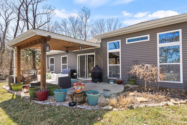 back of property featuring a patio, an outdoor hangout area, and ceiling fan