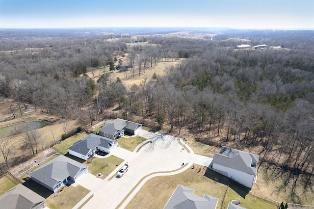 birds eye view of property featuring a forest view