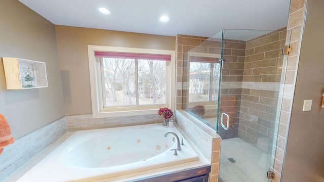 bathroom featuring a jetted tub, a stall shower, and recessed lighting