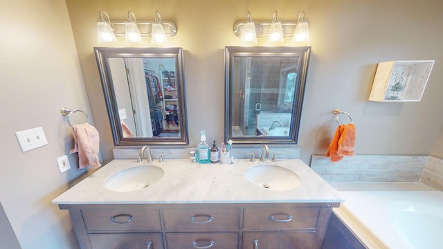 bathroom featuring double vanity, a sink, a bath, and a shower stall