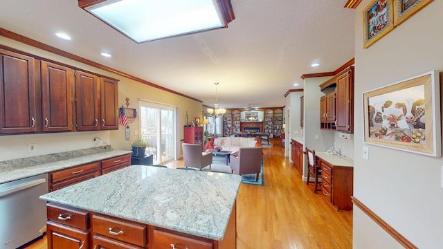 kitchen with a kitchen island, open floor plan, stainless steel dishwasher, ornamental molding, and light wood finished floors