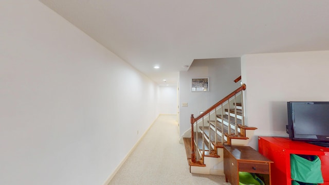 stairway featuring recessed lighting, carpet flooring, and baseboards