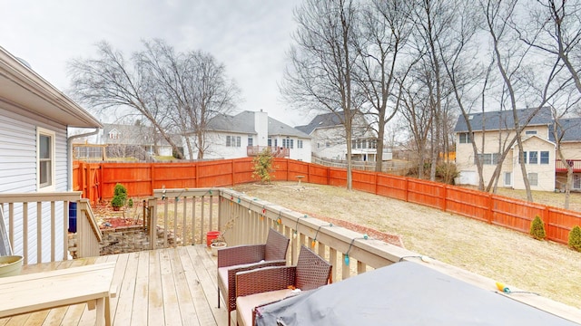 wooden deck featuring a residential view and a fenced backyard