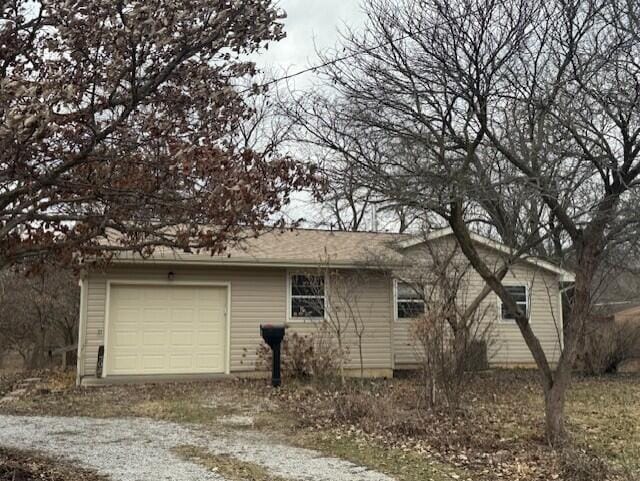 view of home's exterior with an attached garage and driveway