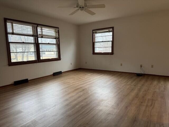 empty room featuring a ceiling fan and wood finished floors