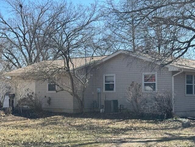 view of side of home featuring cooling unit