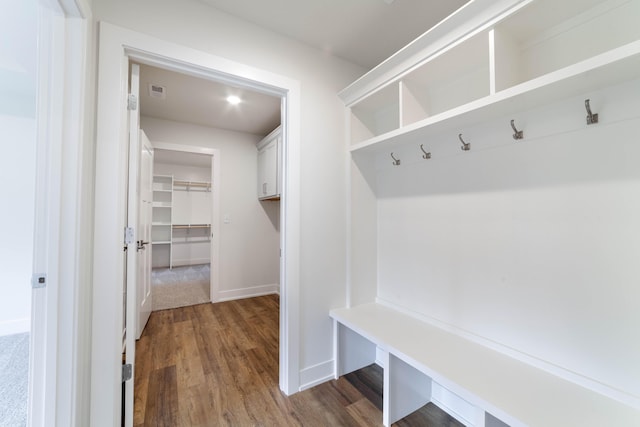 mudroom with baseboards and wood finished floors