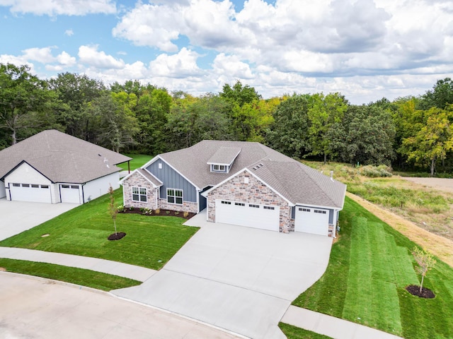 view of front of home featuring an attached garage, a shingled roof, driveway, board and batten siding, and a front yard