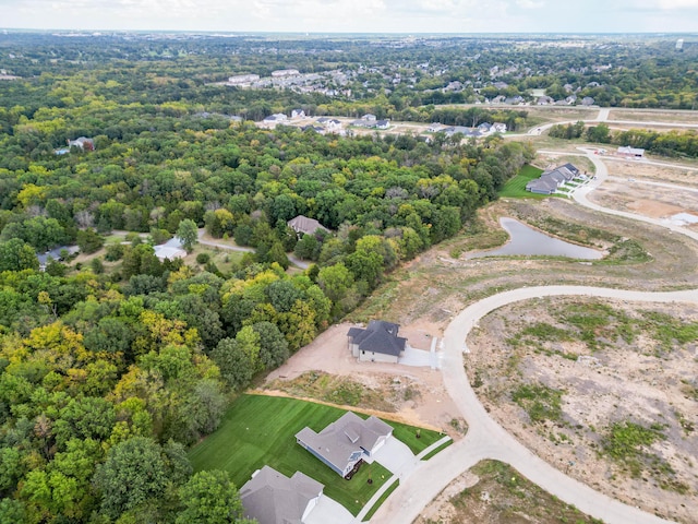 birds eye view of property with a water view and a view of trees