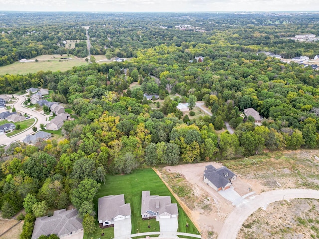 drone / aerial view with a residential view and a view of trees