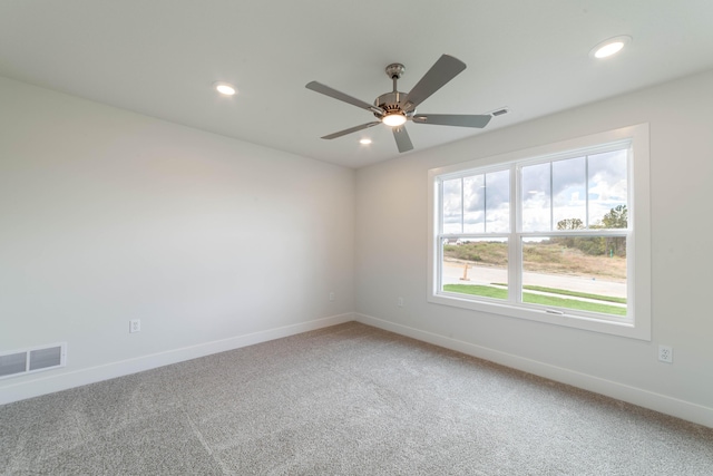 carpeted empty room with visible vents, baseboards, ceiling fan, and recessed lighting