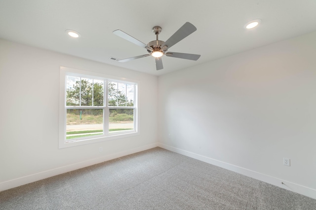 carpeted spare room featuring visible vents, baseboards, a ceiling fan, and recessed lighting