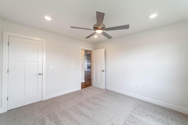 unfurnished bedroom featuring ceiling fan, recessed lighting, carpet, and baseboards